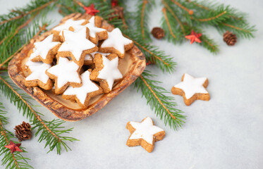 Cinnamon stars, Zimtsterne traditional german christmas cookies in a bowl, gingerbread with anise spice for holidays, fir branches