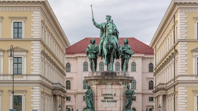 Monument Reiterdenkmal of King Ludwig I of Bavaria timelapse, which is located at the Odeosplatz in Munich, Germany. Front view with historic buildings on a background.