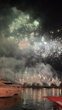 Fireworks over Mediterranean sea, public feast in august. Croatia. Vertical vedeo.