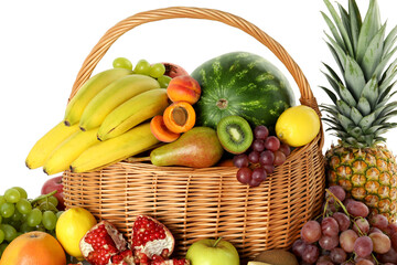 Many different fresh fruits in wicker basket isolated on white