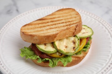 Tasty sandwich with grilled vegetables on plate, closeup
