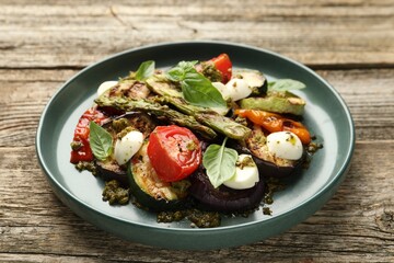 Delicious salad with grilled vegetables on wooden table, closeup