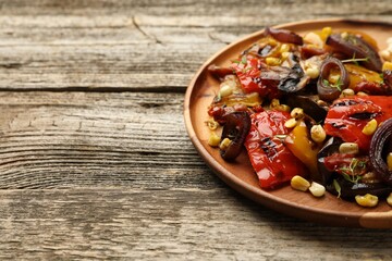 Delicious salad with grilled vegetables on wooden table, closeup. Space for text