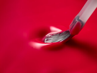 The brush shows the glossy texture of nail polish