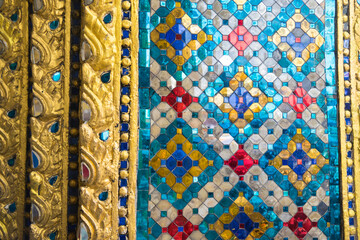 Wat Phra Kaew, Bangkok: Close-Up Mosaic Detail – A Vibrant Showcase of Thai Artistic Craftsmanship and Ornate Decorative Patterns Showing the Rich Cultural Heritage of Thailand's Most Revered Temple