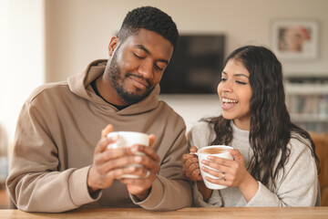 Joyful Conversation Over Warm Mugs in a Cozy Café During a Chilly Afternoon