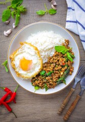Homemade Rice topped with stir fried Thai basil with minced pork and fried egg, pad ka praow moo sap