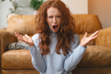 A Frustrated Woman Expresses Her Emotions in a Cozy Living Room Setting During the Afternoon