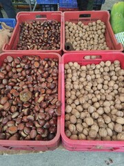 Chestnuts and walnuts displayed in crates at market