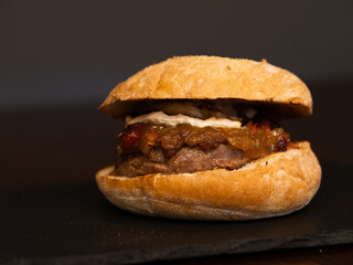 Cheese burger with bacon and egg on black background	
