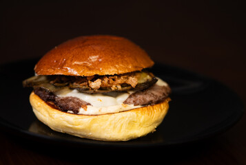 Cheese burger with bacon and egg on black background	
