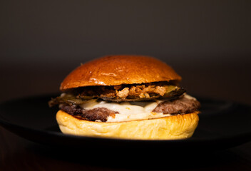 Cheese burger with bacon and egg on black background	
