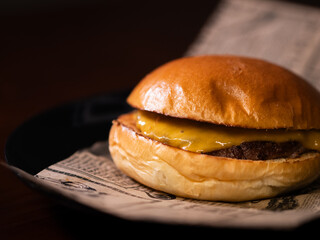Cheese burger with bacon and egg on black background	
