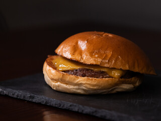 Cheese burger with bacon and egg on black background	
