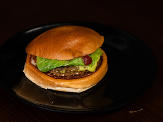 Cheese burger with bacon on black background