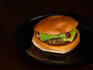 Cheese burger with bacon on black background
