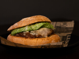 Cheese burger with bacon on black background