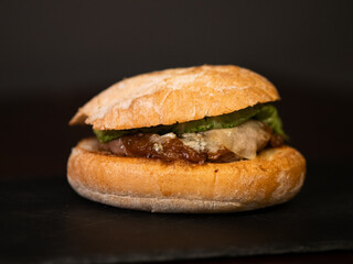 Cheese burger with bacon on black background