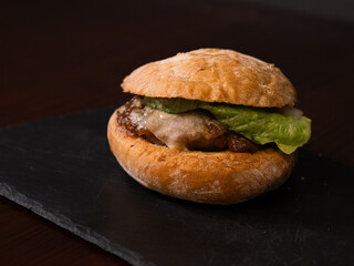 Cheese burger with bacon on black background