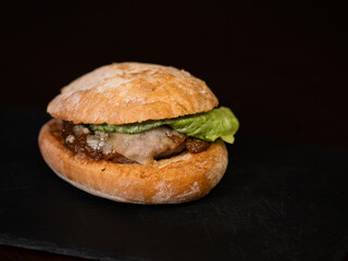 Cheese burger with bacon on black background