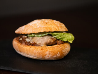 Cheese burger with bacon on black background