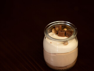 Glass of tiramisú on black background