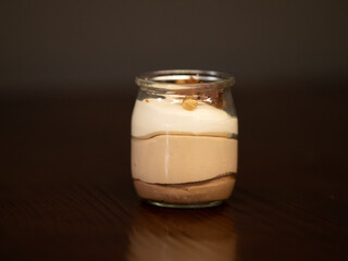 Glass of tiramisú on black background