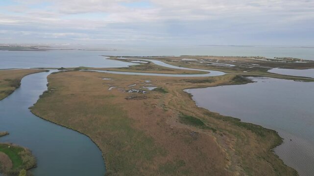 Aerial view of Marano Lagoon winding channels through wetland marshes, Italy