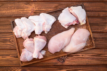 Raw mixed chicken meat parts  for cooking on rustic background