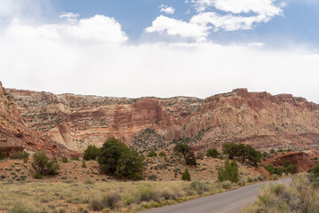 A cloudy and sunny view of red rocks at Capitol Reef National Park in Utah.
