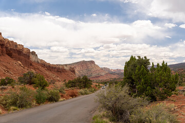 A cloudy and sunny view of red rocks at Capitol Reef National Park in Utah.