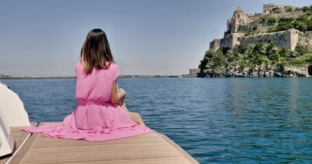 woman on board of yacht, aragonese castle, ischia island, aerial view