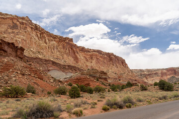 A cloudy and sunny view of red rocks at Capitol Reef National Park in Utah.