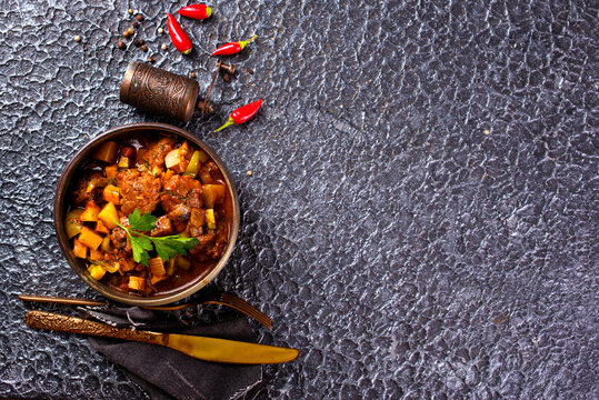 Summer Vegetable spicy stew of zucchini, potatoes, peppers, onions, tomatoes and eggplant in a bowl on the table.