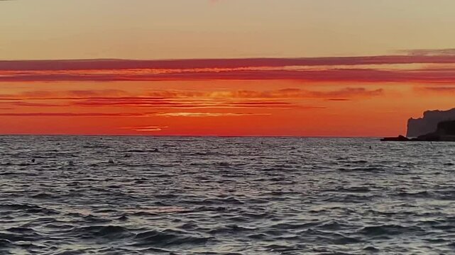 Background. Sunset on the sea. Tenfold acceleration. Fast Waves, wind, Sun setting in the sea. Beautiful view. An unforgettable landscape. Red sunset
