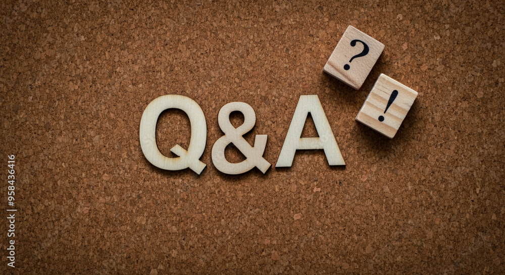 Poster letters and blocks with q&a graphic displayed on corkboard background in a creative educational conc