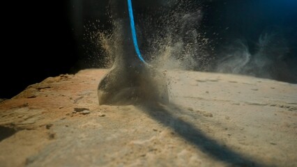 Detailed View of Drilling into Stony Ground with Visible Debris