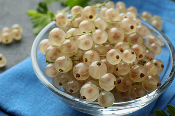 Fresh white currant berries in bowl on table, closeup