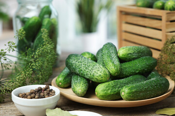 Fresh cucumbers, dill and peppercorns on table, closeup. Preparation for pickling