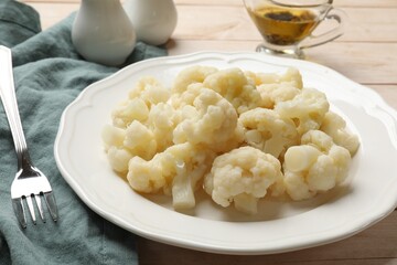 Tasty cooked cauliflower on white wooden table, closeup