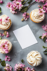 Top view of cupcakes with spring flowers and blank card.