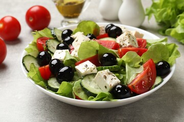 Delicious salad with feta cheese on grey table, closeup