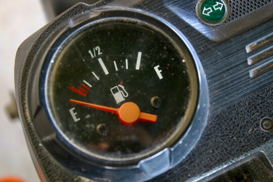 Fuel Gauge. Vehicle fuel level indicator gauge. Vehicle fuel level indicator gauge while showing empty tank.