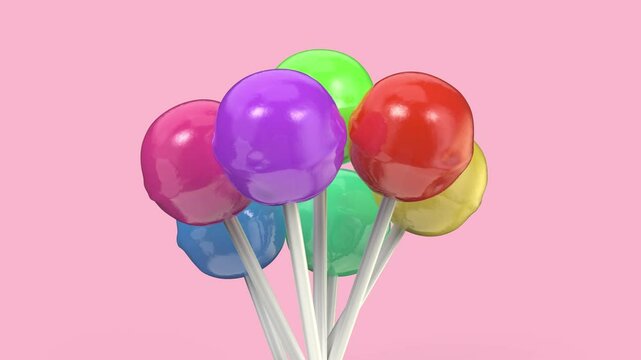 Group of lollipops with different colors and flavors on pink background