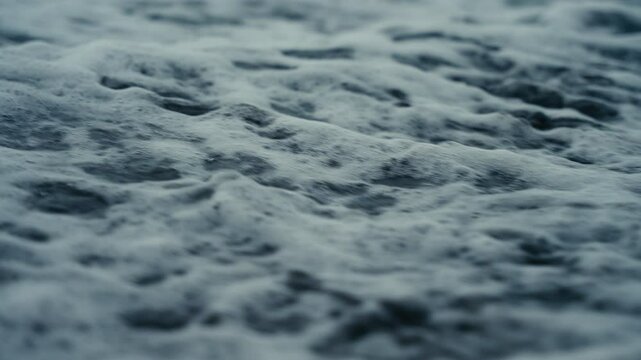 Water running over the sand of a tropical beach at dusk