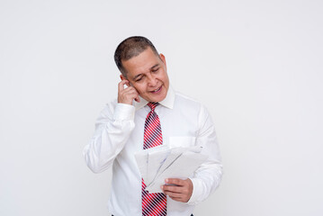A middle-aged office professional scratching his head, looking annoyed at mounting out of control bills. Isolated on a white background.
