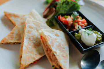 Chicken quessadilla with tomato salsa and avocado guacamole