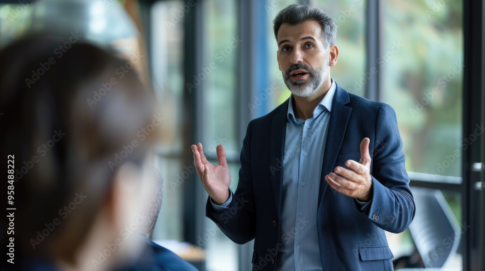 Poster a man in formal attire passionately discusses topics while addressing an engaged audience in a conte