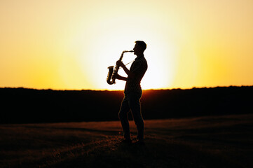 An enchanting and captivating silhouette of a skilled saxophonist set against a stunningly vibrant sunset backdrop