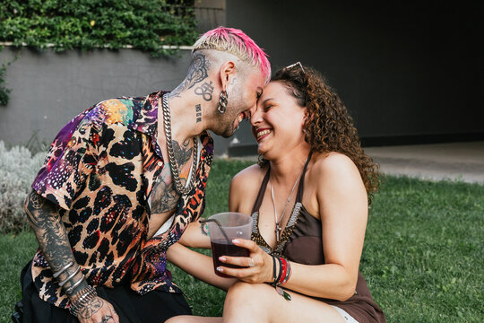 Affectionate couple sharing a moment during an outdoor gathering - Powered by Adobe